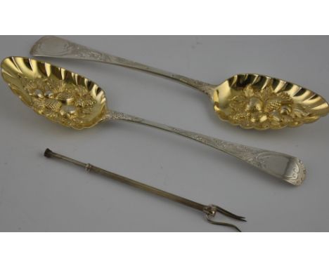 A pair of berry spoons, London 1799, with later repousse decoration and gilded bowls, together with a pickle fork, 40zt, (3)