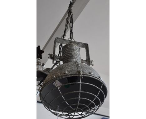 A silver painted industrial style hanging light fitting