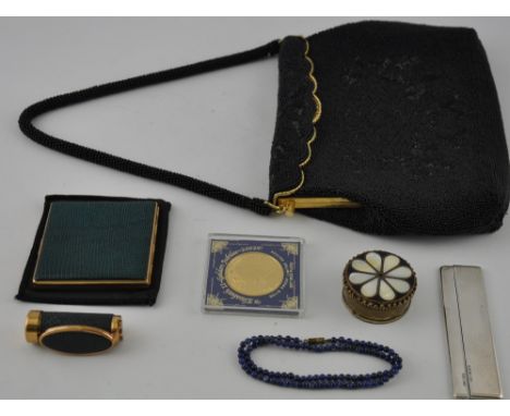 A ladies evening bag, with a black bead decoration and gilt metal frame, together with a compact and matching lip-stick, silv