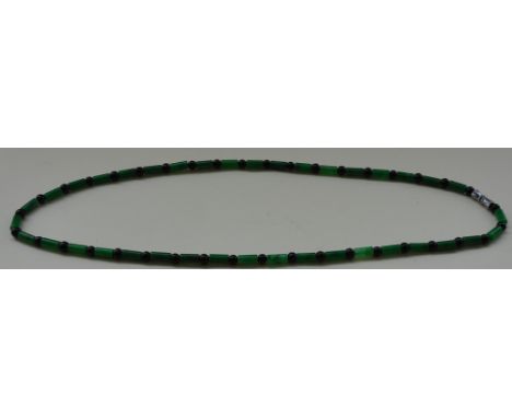 A jade bead necklace, of cylindrical batons and black agate beads. 