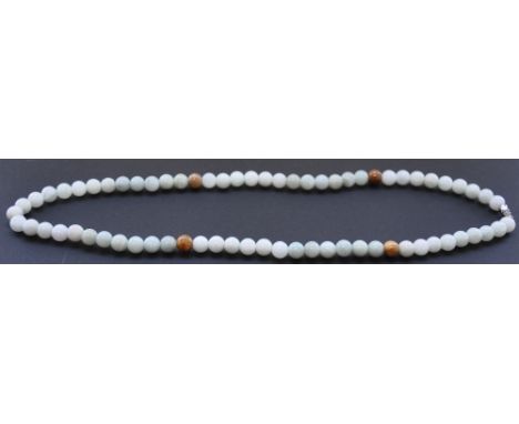 A jade bead necklace, of uniform dimensions. 