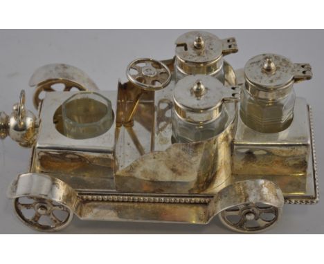 A novelty silver plated four bottled cruet modelled as a vintage car, L: 18cm