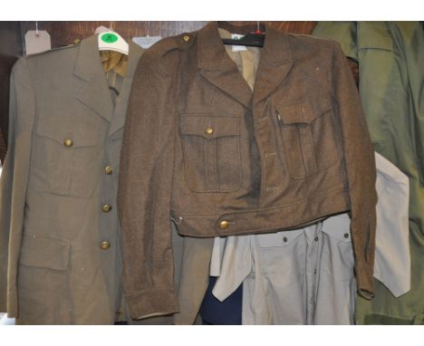 A quantity of assorted military tunics, jackets and uniforms, including an American khaki light weight jacket, Tropical Stone