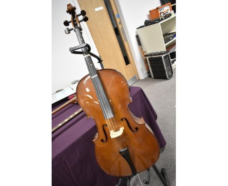 A traditional Cello , Stentor label, on stand