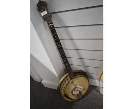 A traditional 4 string banjo, probably John Grey, badge worn