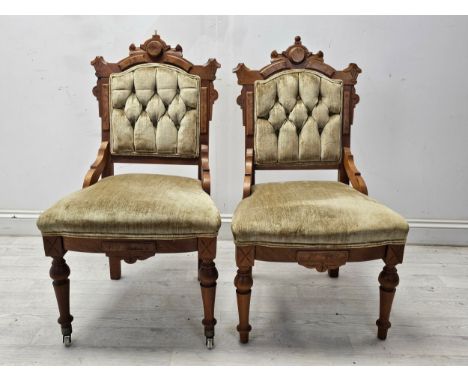 Salon chairs, a pair, late 19th century walnut in deep buttoned velvet upholstery. H.94 W.52 D.55cm. (One finial missing as s