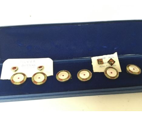 A collection of white metal and enamel buttons and silver buttons in a fitted box.