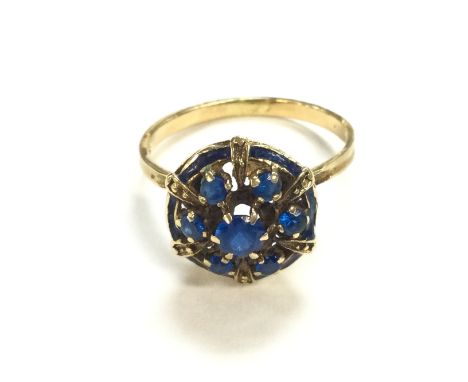 An 18ct gold blue gemstone cluster ring. Size O and 4.15g Postage B