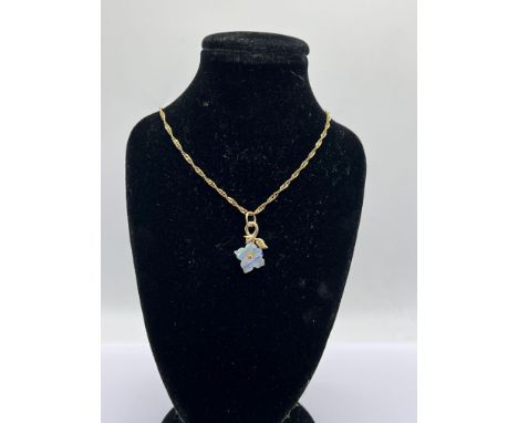 A fine 14ct gold and carved opal pendant with a 9ct gold chain, 2.87g, (A)