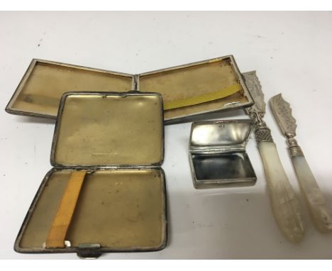 Two silver cigarette cases two silver butter knifes with mother of pearl handles and a silver engine turned snuff box with go