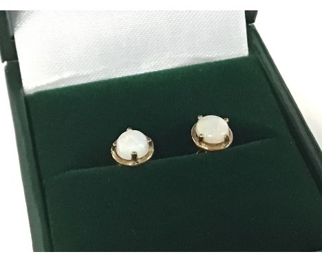 A pair of 9ct opal gold earrings. Postage category A