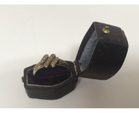 An unmarked Antique gold ring set with a pattern of seed pearl. ring size U.