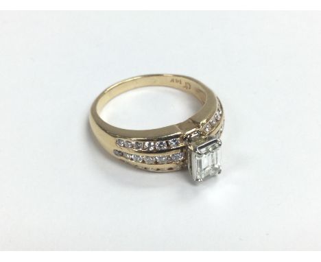 A 14ct gold emerald cut diamond solitaire ring with further diamonds to the shoulders, approx 0.58ct, approx 6.3g and approx 