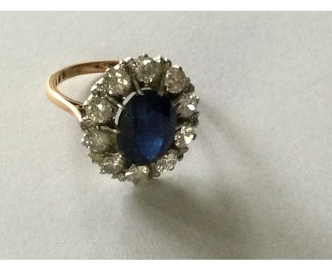 A Sapphire and diamond cluster ring surrounded by ten 15 point diamonds Size L .