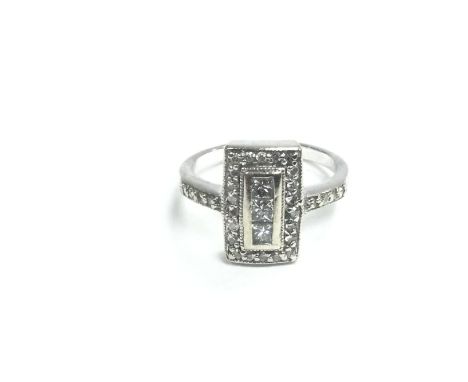 An 18ct white gold rectangular shaped diamond cluster ring, approx 5.1g and approx size O. Shipping category A.