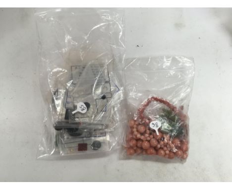 A bag of mixed stones including coral, jade and other stones. Shipping category A.