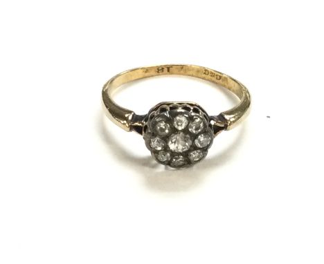 An 18ct gold diamond cluster ring weighing 2.90g and size O. Postage B