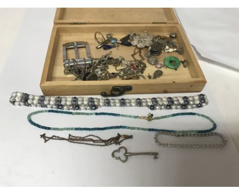 A box of jewellery including silver charms and a Tiffany key