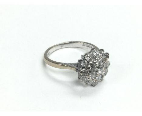 An 18ct white gold diamond cluster ring, two atones missing, approx 4g and approx size K. Shipping category A.