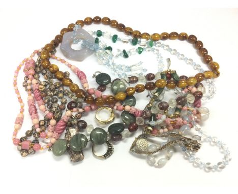 A small collection of costume jewellery including a jade pendant, various bead necklaces etc. Shipping category A.