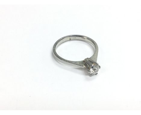 An 18ct white gold diamond solitaire ring, approx .25ct, approx 2.5g and approx size M. Shipping category A.