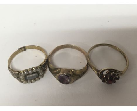 Three antique gold rings including a mourning ring set with seed pearl an intaglio set ring and one with garnets (cut)