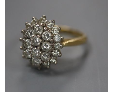 A diamond cluster ring , the oval set with 26 brilliants in three tiers, 18ct yellow gold setting and shank, size N.