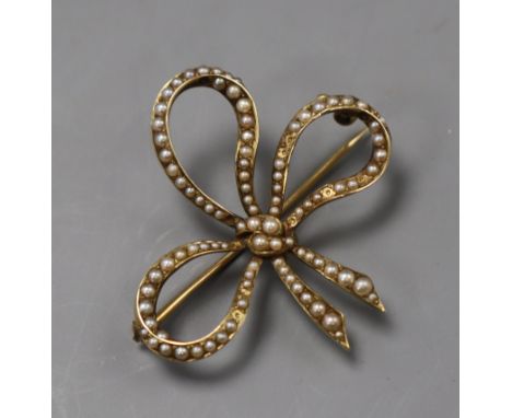 A 14k yellow metal and seed pearl set bow brooch, 37mm.