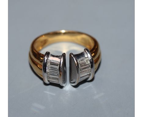 A two-colour yellow metal and diamond ring with set baguette-cut diamonds (tests as 18ct), size K/L.