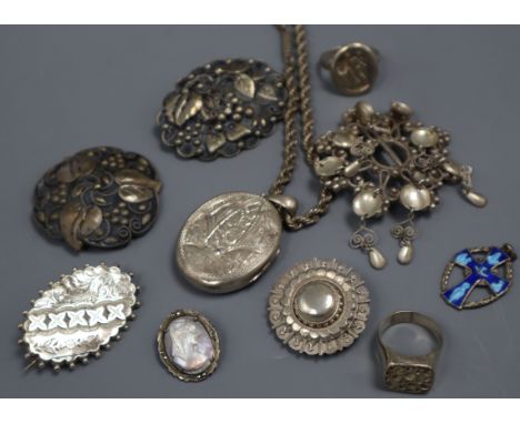 A group of mixed silver and white metal jewellery including a Victorian locket and an antique signet ring.