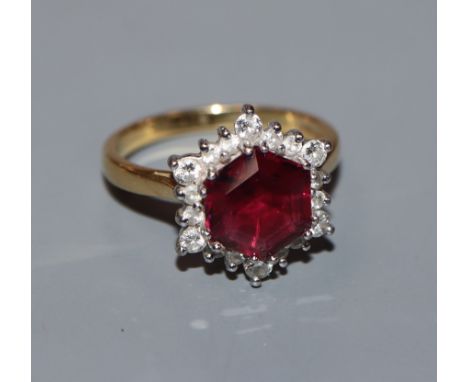 A garnet and diamond hexagonal cluster ring on 18ct yellow gold shank, size M.