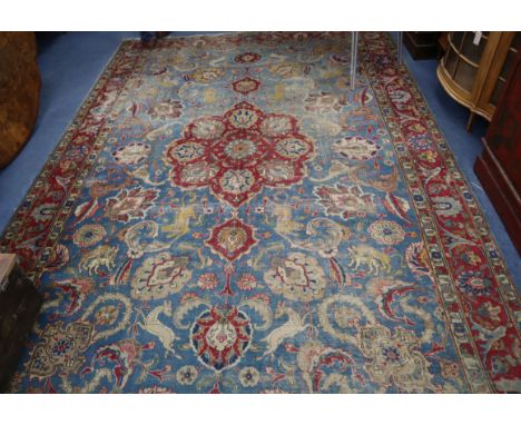 A Tabriz pale blue ground carpet, woven with hunting animals and floral medallions 350 x 240cm