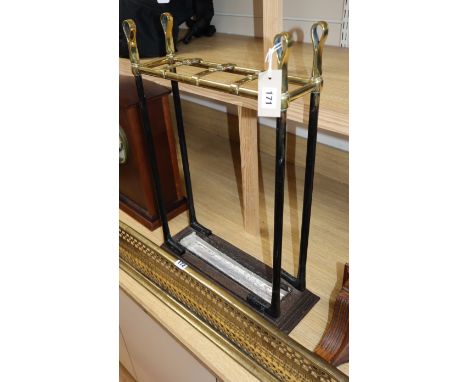 A Victorian brass and iron stick stand