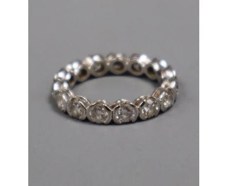 A modern 18ct white gold and diamond full eternity ring, set with fifteen part collet set round cut stones, size S.