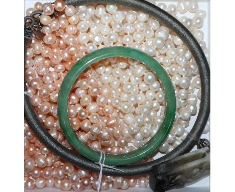 Two cultured pearl opera length necklaces (white and champagne), a green jade bangle and a jade pendant on silk cord neck sus