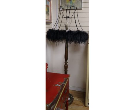 A giltwood lamp standard with feathered shade