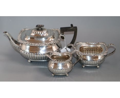 An Edwardian three-piece silver tea service of half-fluted gadrooned form, London 1906, William Hutton &amp; Sons Ltd, approx