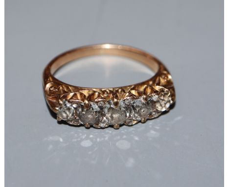 A diamond five-stone half-hoop ring with yellow metal scrolled setting and shank (tests as 14ct), size G.