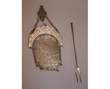 A sterling silver toasting fork and a white metal clutch bag with a sterling silver belt clasp 