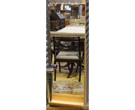 A contemporary rectangular hall mirror with a bentwood under shelf