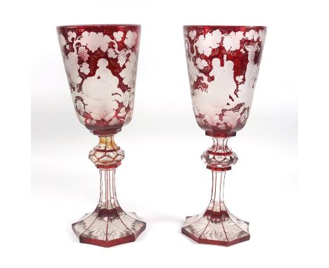 A pair of 19th Century Bohemian glass goblets, ruby flashed wheel cut decoration of Bacchus among fruiting vines, height 30.8