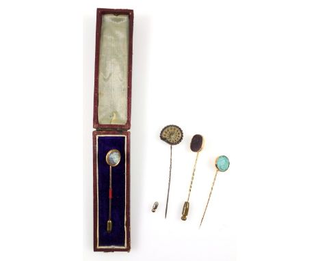 A group of antique stick pins, intaglio cut hardstone example depicting a man and horse, white chalcedony head in relief, car