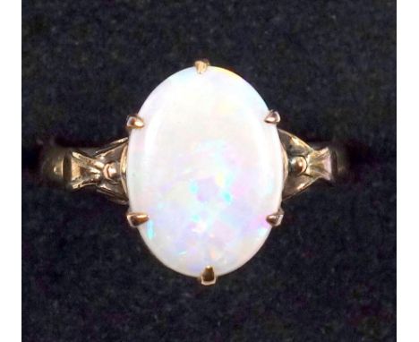 Opal ring, claw set with leaf shoulders, set in yellow metal, on associated 18 ct gold band 