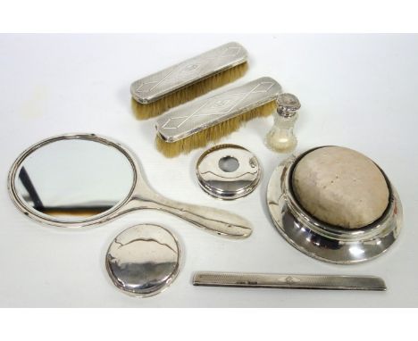 Silver four piece toilet set with engine turned decoration, comprising a hand mirror, pair of clothes brushes and a comb moun