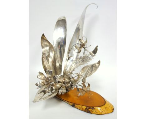 20th C. design silver floral centrepiece with five sprigs of flowers within six leaves, on a rocky base, by J H, Harrow or Ho