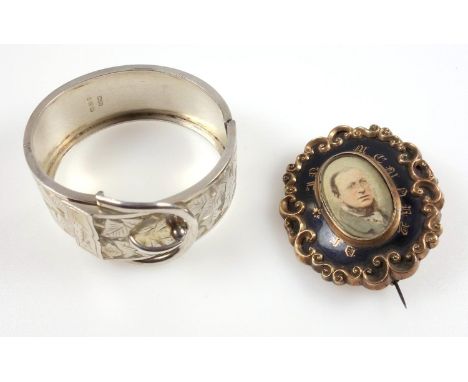 Silver buckle bangle with engraving of ivy leaves, by William James Dingley, Birmingham 1885, and a gilt metal memorial brooc