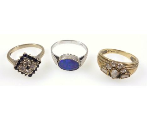 Three gem set rings, sapphire and diamond cluster, and an opal doublet ring, both set in 18 ct, and a ring set with synthetic