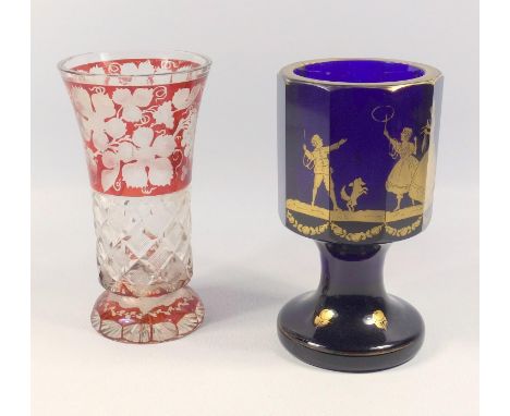 Bohemian ruby flash vase decorated with vines, 15.5 cm and a cobalt goblet with gilt decoration of children and a dog playing