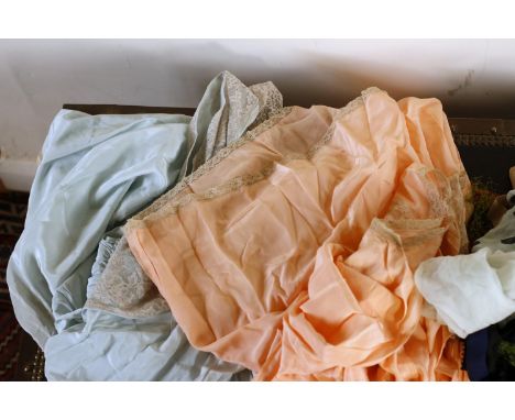 1930?s two silk petticoats, one apricot another in pale blue both with lace trim, hair nets with ribbon, a blouse with pintuc