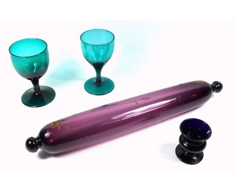 19th C. coloured glass, an amethyst glass rolling pin, 40 cm, a campana form Bristol glass egg cup and two emerald glass wine